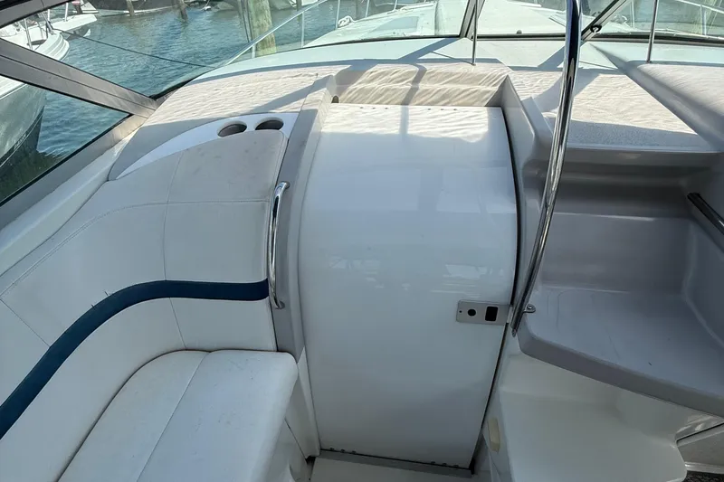 Slide: The Image of Interior of a 1999 Formula 400 Super Sport boat with white seating and cup holders. - 21