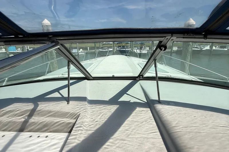 Slide: The Image of 1999 Formula 400 Super Sport boat interior view with clear windshield and marina background. - 22