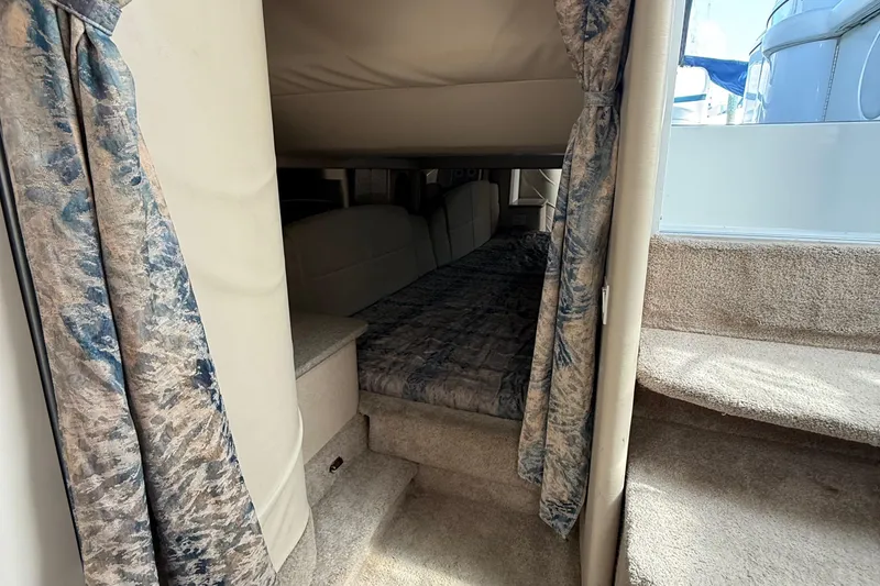 Slide: The Image of Interior cabin view of a 1999 Formula 400 Super Sport boat with cozy bedding. - 27