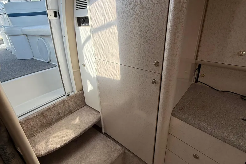 Slide: The Image of Interior of 1999 Formula 400 Super Sport boat, featuring stairs and cabinetry. - 28