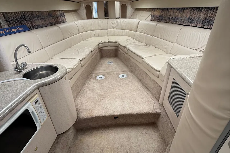 Slide: The Image of Interior of 1999 Formula 400 Super Sport boat with plush seating and kitchenette. - 30