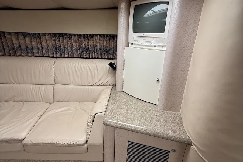 Slide: The Image of 1999 Formula 400 Super Sport interior with beige seating and built-in TV. - 31