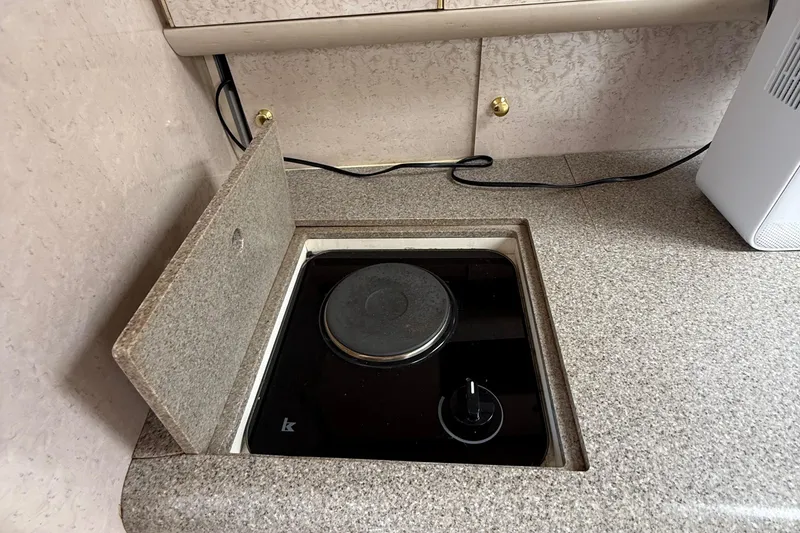 Slide: The Image of 1999 Formula 400 Super Sport boat kitchen with built-in electric stove. - 35