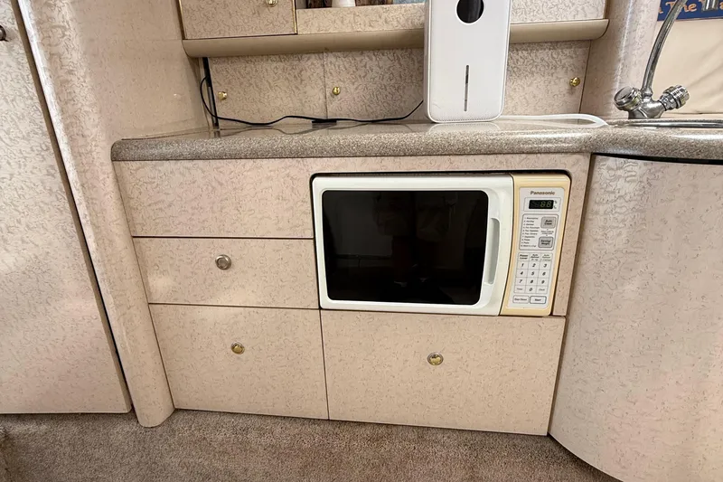 Slide: The Image of Interior of a 1999 Formula 400 Super Sport with built-in microwave and cabinetry. - 37