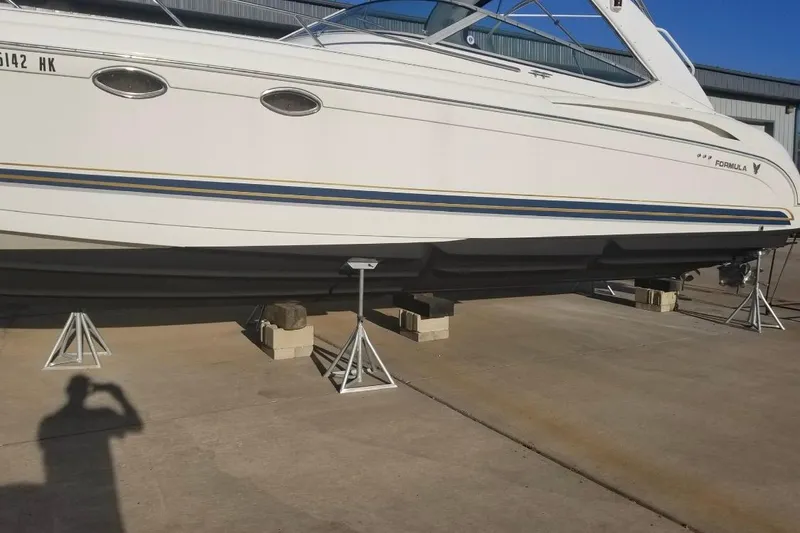 Slide: The Image of 1999 Formula 400 Super Sport boat on stands in a marina setting. - 38