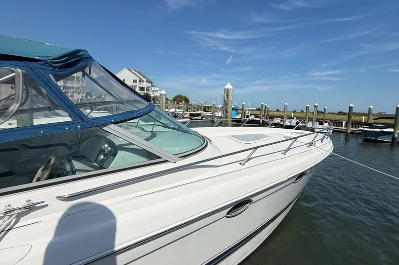 Slide: The Image of 1999 Formula 400 Super Sport boat docked at marina under clear blue sky. - 4
