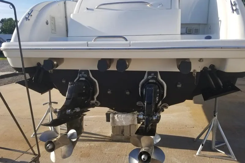 Slide: The Image of 1999 Formula 400 Super Sport boat stern with dual propellers on a concrete surface. - 42