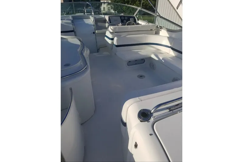 Slide: The Image of 1999 Formula 400 Super Sport boat interior with white seating and control panel. - 43