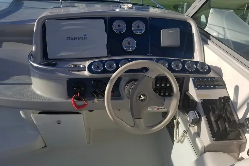 Slide: The Image of 1999 Formula 400 Super Sport boat dashboard with Garmin navigation system and steering wheel. - 44