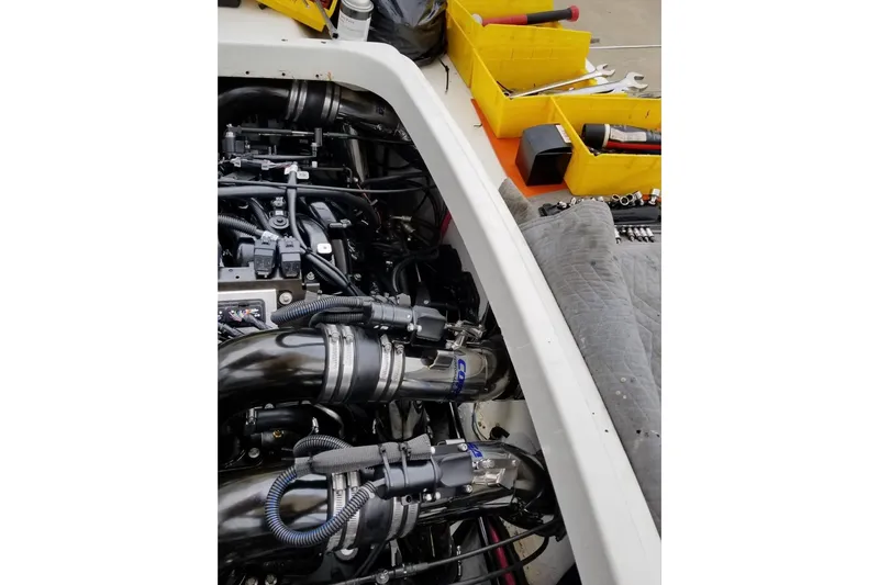 Slide: The Image of Engine compartment of a 1999 Formula 400 Super Sport with tools and parts nearby. - 48