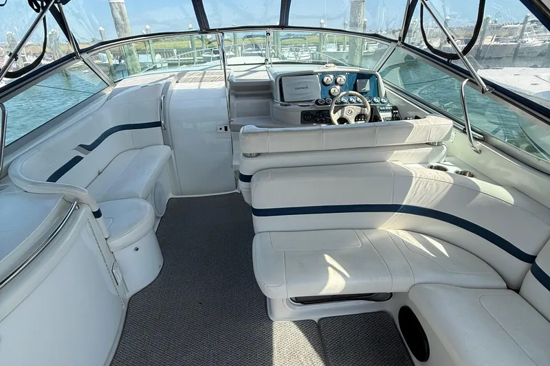 Slide: The Image of Interior of a 1999 Formula 400 Super Sport boat with white seating and control panel. - 5
