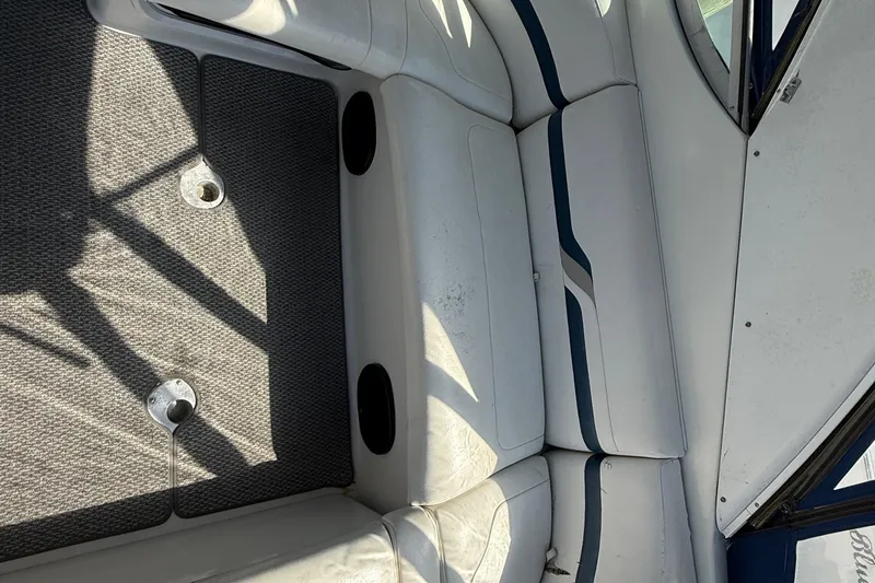 Slide: The Image of Interior seating of a 1999 Formula 400 Super Sport boat, featuring white and blue upholstery. - 8