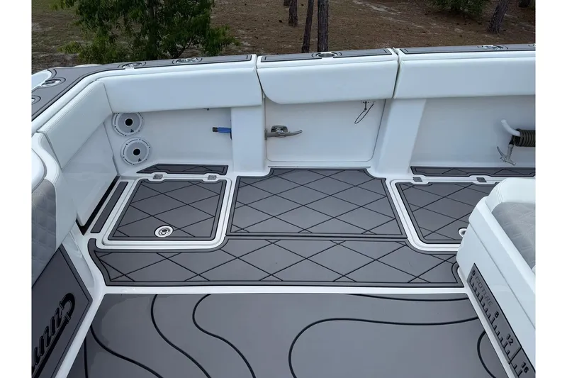 Slide: The Image of 2022 Invincible 40 Catamaran deck with sleek gray flooring and white seating. - 5