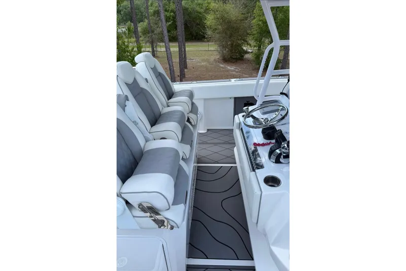 Slide: The Image of Luxurious seating and helm of 2022 Invincible 40 Catamaran, featuring sleek design and modern controls. - 7