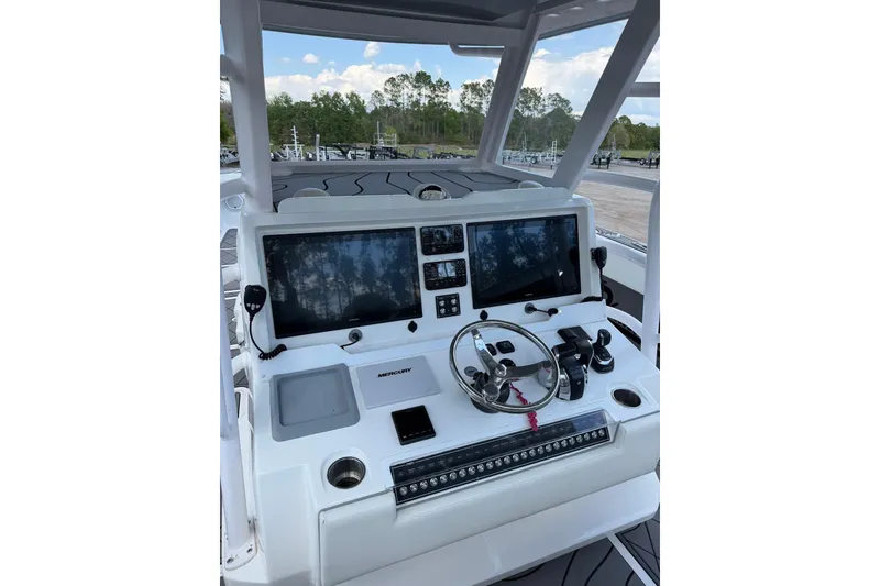 Slide: The Image of Helm of 2022 Invincible 40 Catamaran featuring dual screens and modern controls. - 8