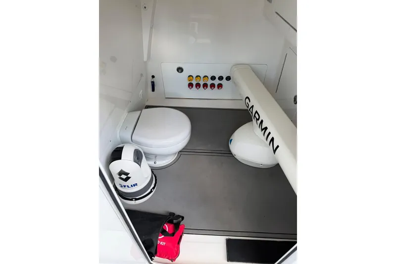 Slide: The Image of Interior of 2022 Invincible 40 Catamaran featuring toilet, Garmin equipment, and safety gear. - 9