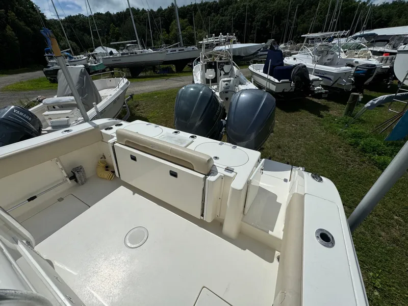 Slide: The Image of 2013 Cobia 296 Center Console boat with dual engines, docked among other boats. - 10