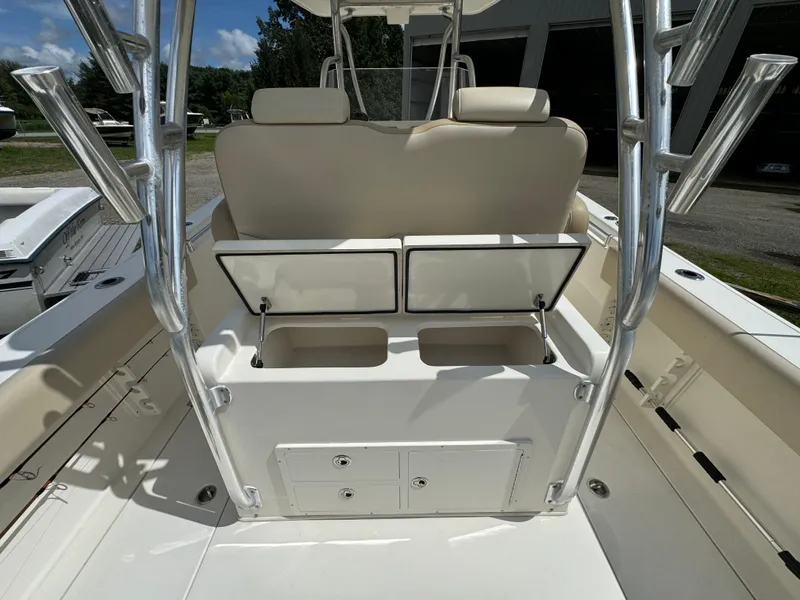 Slide: The Image of 2013 Cobia 296 Center Console boat interior with storage compartments open. - 16