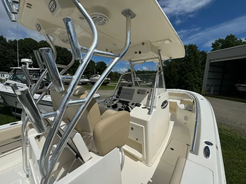 Slide: The Image of 2013 Cobia 296 Center Console boat with sleek design and modern controls. - 19