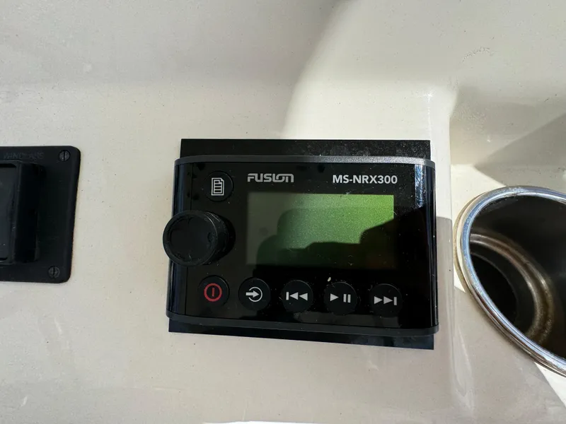 Slide: The Image of Fusion MS-NRX300 marine stereo on 2013 Cobia 296 Center Console boat dashboard. - 24