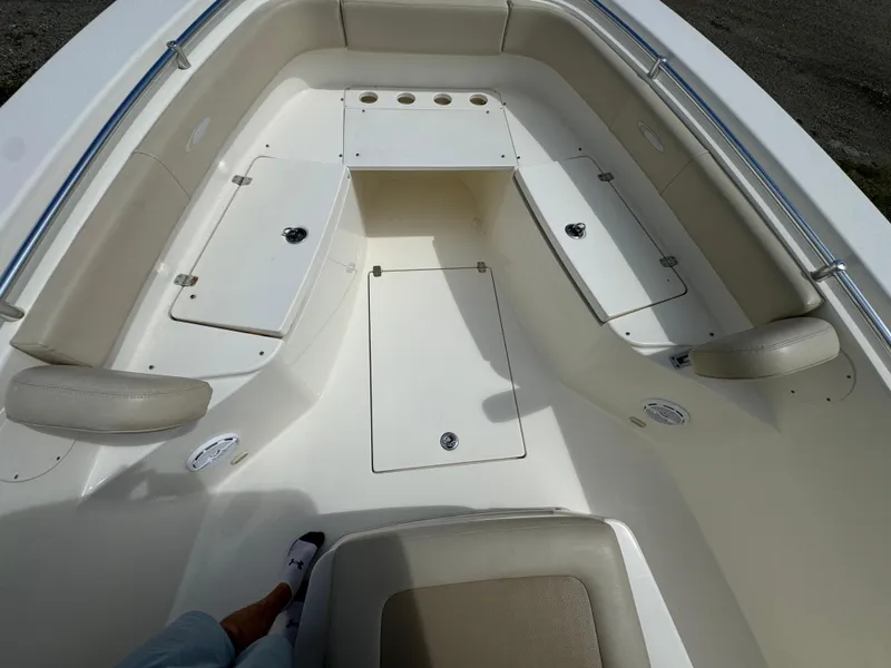 Slide: The Image of 2013 Cobia 296 Center Console boat interior with storage compartments and seating. - 34