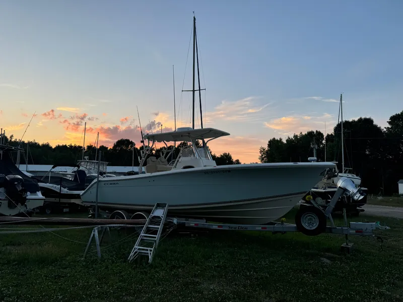 Slide: The Image of 2013 Cobia 296 Center Console boat on trailer at sunset. - 41