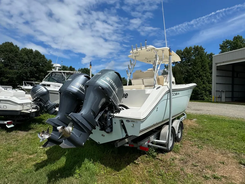 Slide: The Image of 2013 Cobia 296 Center Console boat with dual Yamaha outboard engines on a trailer. - 6