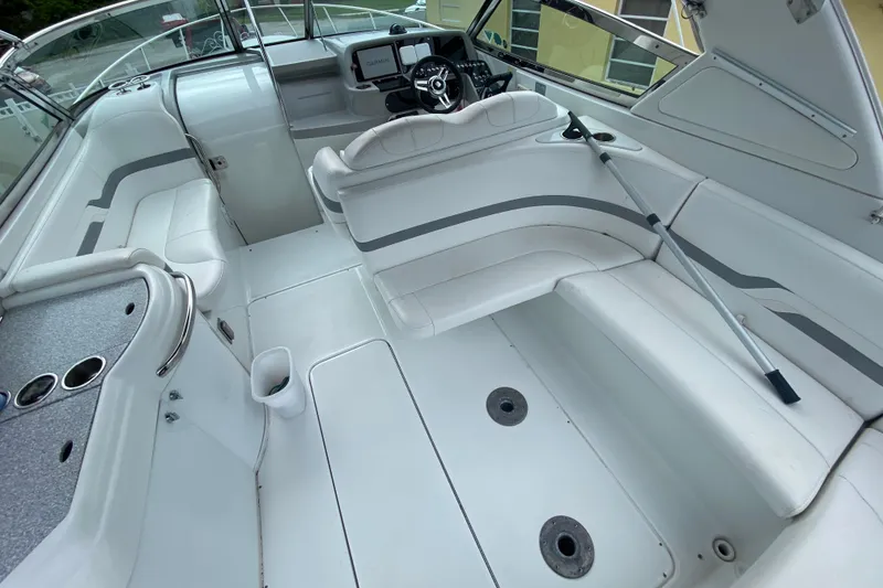 Slide: The Image of 2009 Formula 330 Sun Sport boat interior with white seating and steering console. - 15