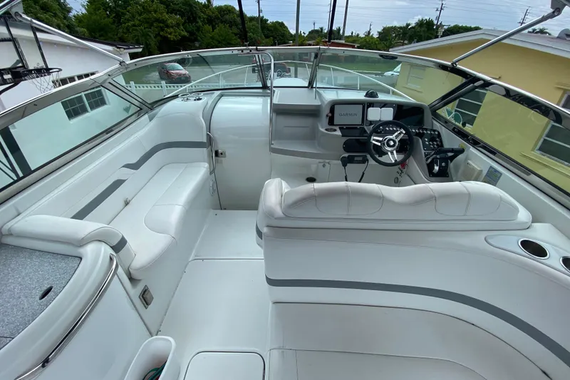 Slide: The Image of 2009 Formula 330 Sun Sport boat interior with white seating and modern dashboard. - 16