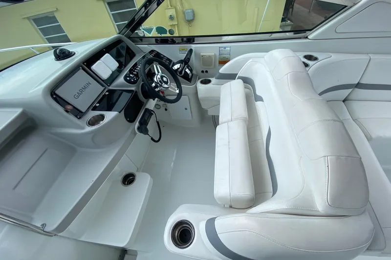Slide: The Image of 2009 Formula 330 Sun Sport boat interior with Garmin navigation and white seating. - 18