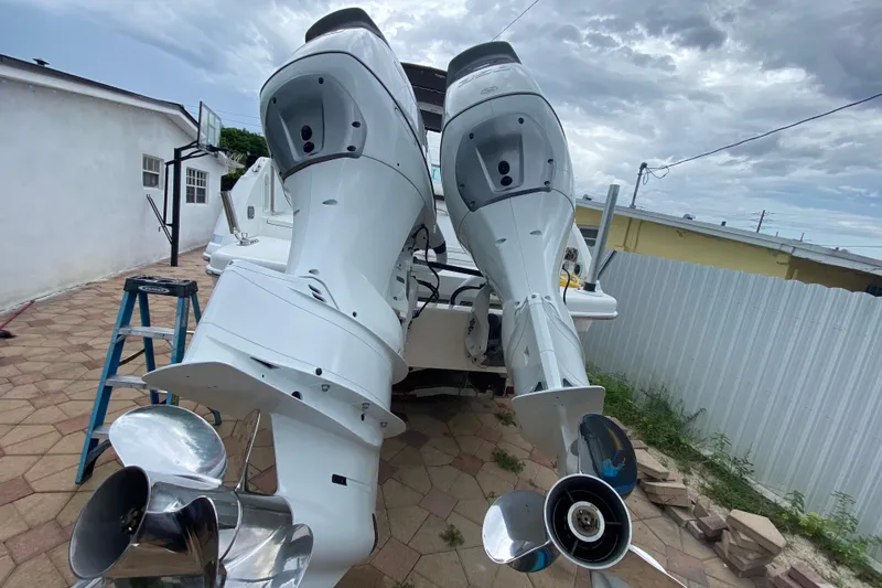 Slide: The Image of 2009 Formula 330 Sun Sport boat with dual outboard motors in a driveway. - 28