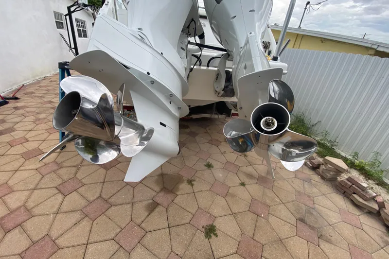 Slide: The Image of 2009 Formula 330 Sun Sport boat propellers on a paved patio. - 30