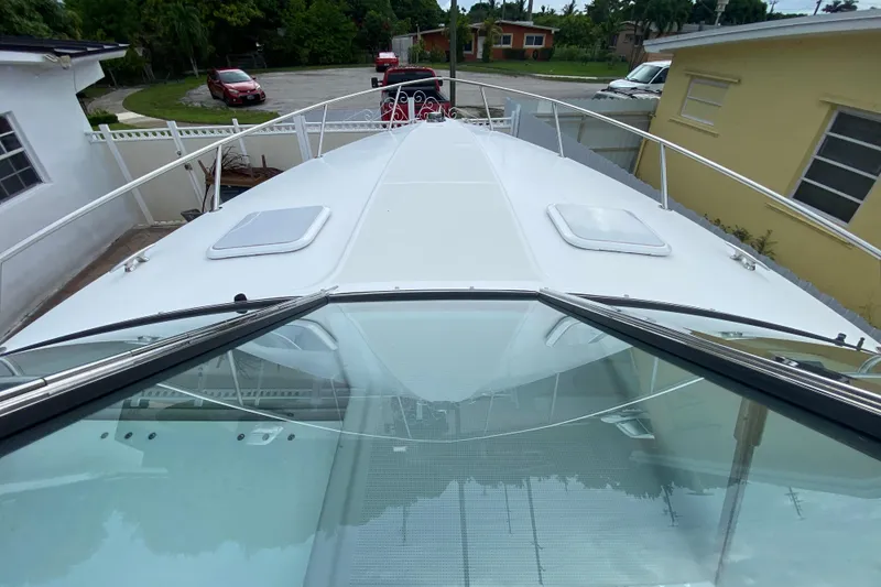 Slide: The Image of 2009 Formula 330 Sun Sport boat docked in residential driveway, top view. - 9