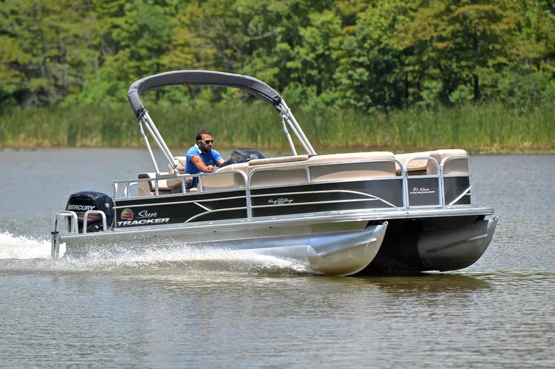 The Image of 2018 Sun Tracker Party Barge 20 pontoon boat cruising on a lake. - 1