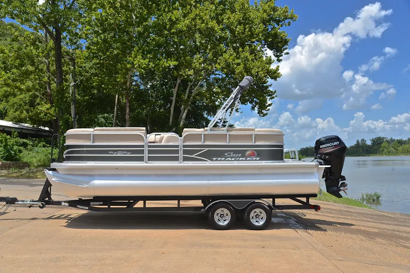 Slide: The Image of 2018 Sun Tracker Party Barge 20 pontoon boat on trailer by a lake. - 10