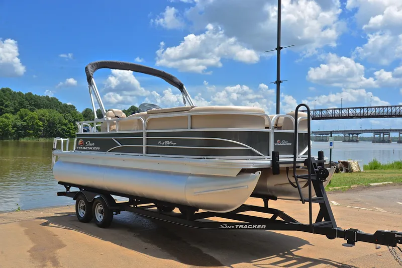 Slide: The Image of 2018 Sun Tracker Party Barge 20 pontoon boat on trailer by a scenic river. - 15