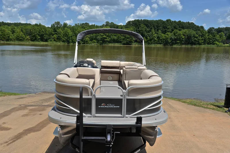 Slide: The Image of 2018 Sun Tracker Party Barge 20 pontoon boat by a serene lake. - 16