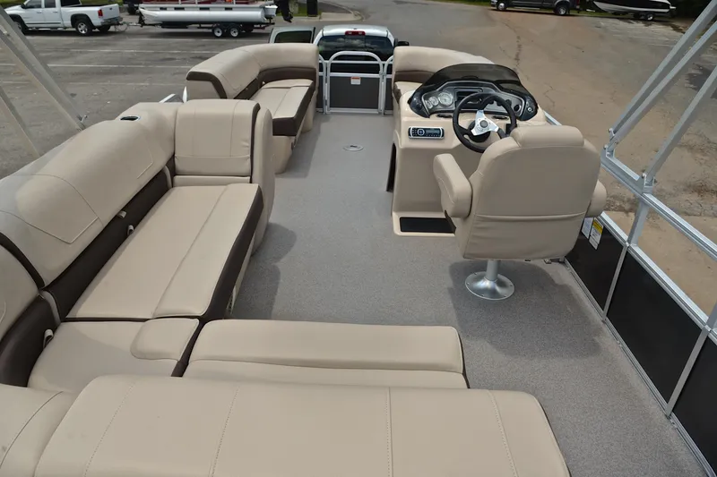 Slide: The Image of 2018 Sun Tracker Party Barge 20 interior with beige seating and steering console. - 17