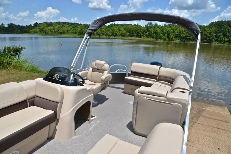 Slide: The Image of 2018 Sun Tracker Party Barge 20 pontoon boat on a serene lake. - 21