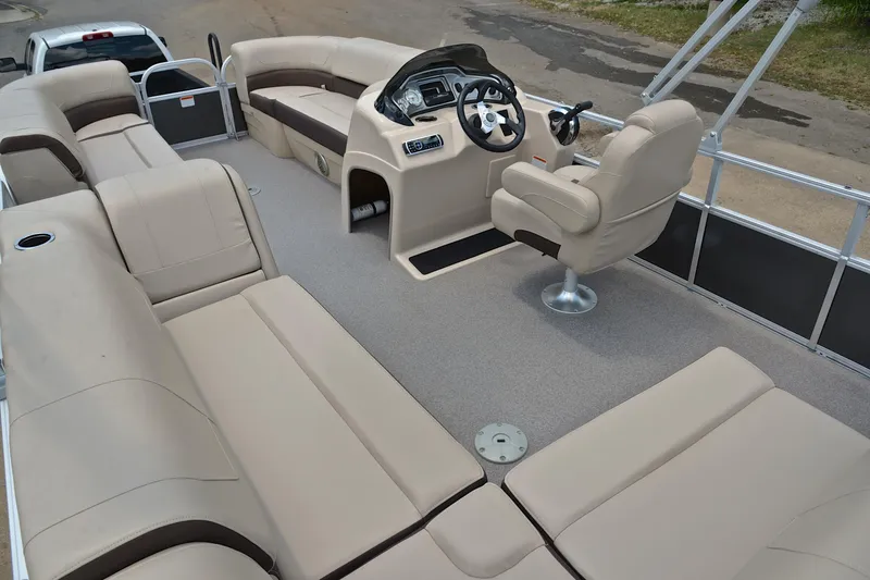 Slide: The Image of 2018 Sun Tracker Party Barge 20 interior with beige seating and steering console. - 23