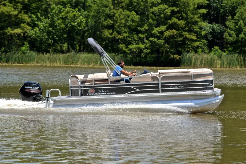 Slide: The Image of 2018 Sun Tracker Party Barge 20 pontoon boat cruising on a lake. - 3