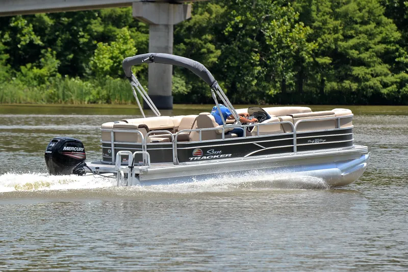 Slide: The Image of 2018 Sun Tracker Party Barge 20 pontoon boat cruising on a lake. - 5