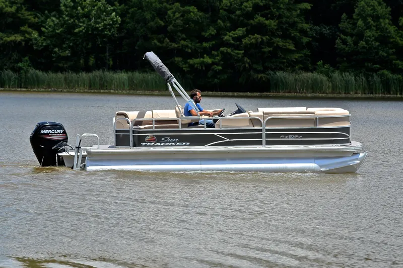 Slide: The Image of 2018 Sun Tracker Party Barge 20 pontoon boat cruising on a calm lake. - 6