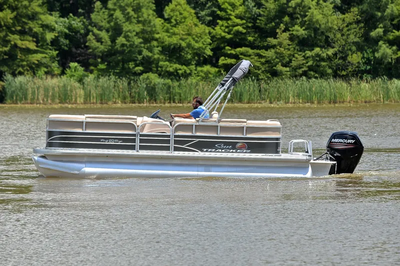 Slide: The Image of 2018 Sun Tracker Party Barge 20 pontoon boat cruising on a lake. - 8