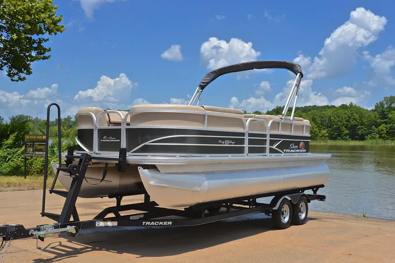 Slide: The Image of 2018 Sun Tracker Party Barge 20 pontoon boat on trailer by a lake. - 9