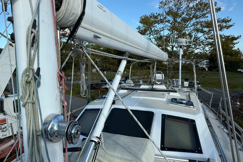 Slide: The Image of Sailboat deck view of 2011 Tartan 4700, featuring rigging and mast details. - 12