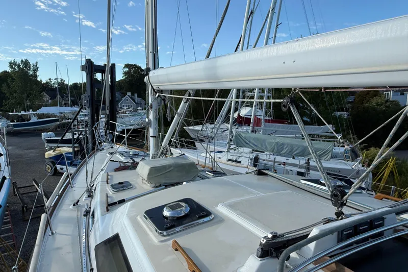 Slide: The Image of Sailboat deck view of 2011 Tartan 4700, docked with other boats under clear sky. - 14
