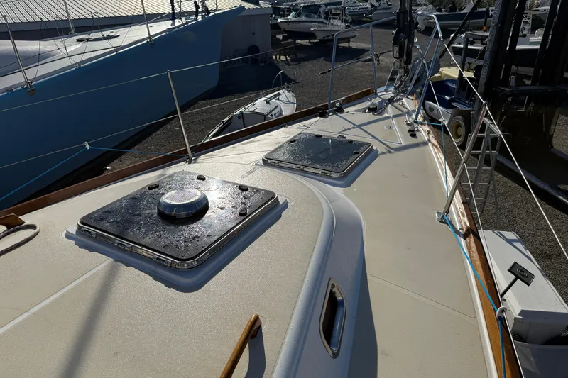 Slide: The Image of Deck view of a 2011 Tartan 4700 sailboat in a marina setting. - 19