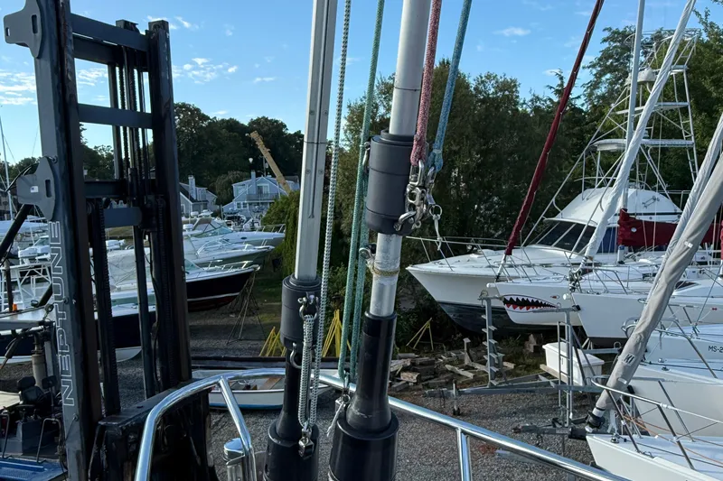 Slide: The Image of Boats in a marina with a Tartan 4700 sailboat mast, 2011 model, in the foreground. - 21