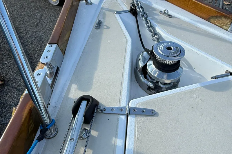 Slide: The Image of Deck of 2011 Tartan 4700 sailboat featuring anchor winch and chain. - 22
